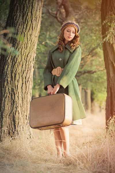 Photo of beautiful young woman with suitcase on the wonderful tr — Stock Photo, Image