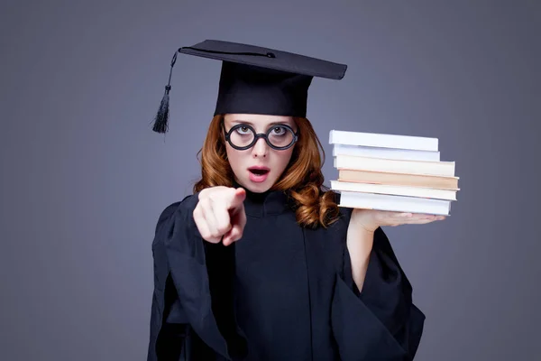 Foto von schönen jungen Alumnus mit Stapel Bücher auf dem Wunder — Stockfoto