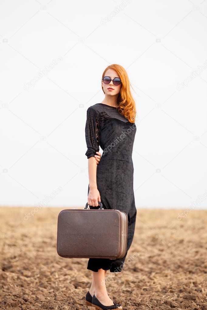 photo of beautiful young woman with suitcase on the wonderful fi