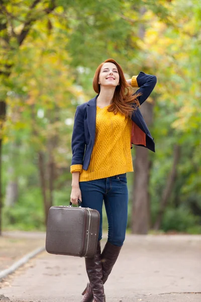 Beautiful young woman with suitcase — Stock Photo, Image