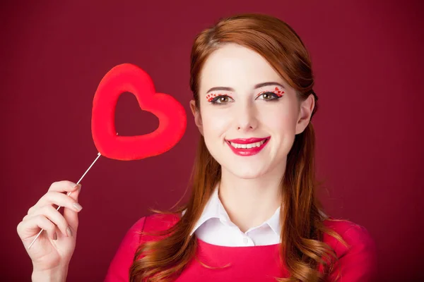 Young woman with heart shaped toy — Stock Photo, Image