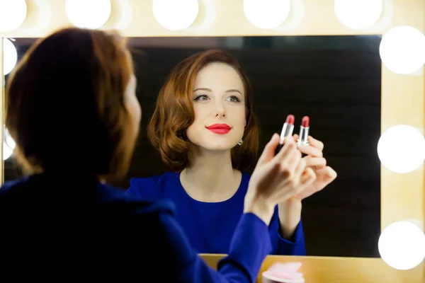 Mooie jonge vrouw bedrijf lippenstift — Stockfoto