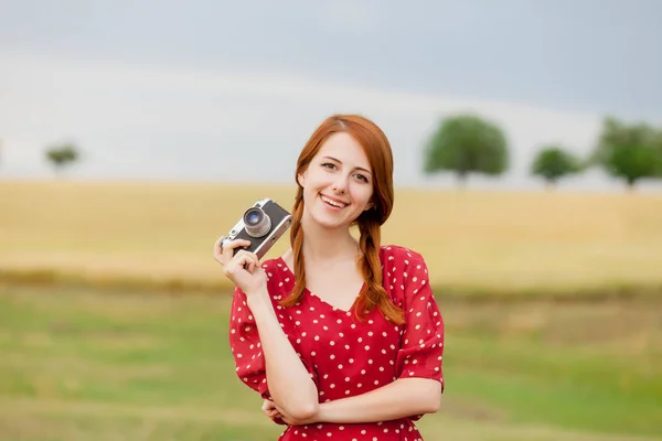 Young woman holding retro camera — Stock Photo, Image