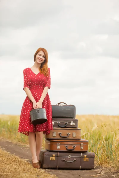 Beautiful young woman with suitcases — Stock Photo, Image