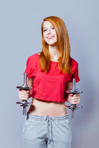 Beautiful young woman with dumbbells — Stock Photo, Image