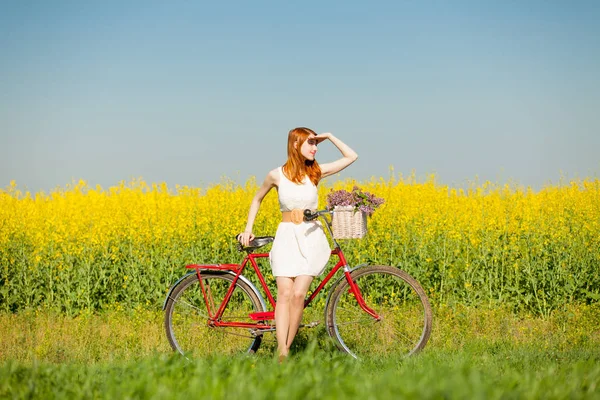 Beautiful young woman with bicycle — Stock Photo, Image