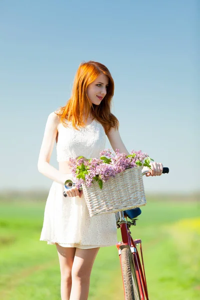 Beautiful young woman with bicycle — Stock Photo, Image