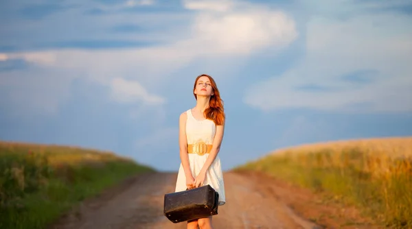 Beautiful young woman with suitcase — Stock Photo, Image