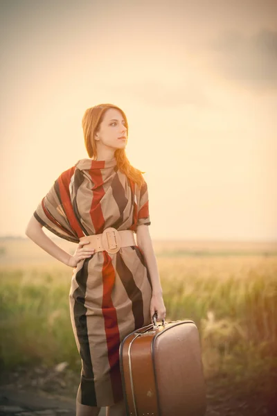 Beautiful young woman with suitcase — Stock Photo, Image