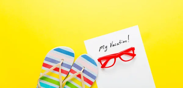 Sandals and paper with lettering "my vacation!" on the desk — Stock Photo, Image