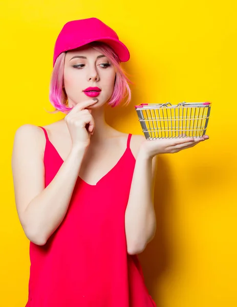 Beautiful young woman with shopping basket — Stock Photo, Image