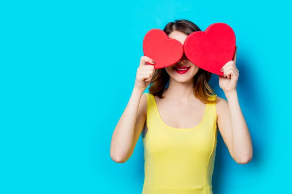 Young woman with heart shaped gift — Stock Photo, Image