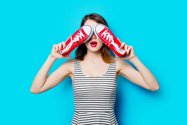 Young woman with red gumshoes — Stock Photo, Image
