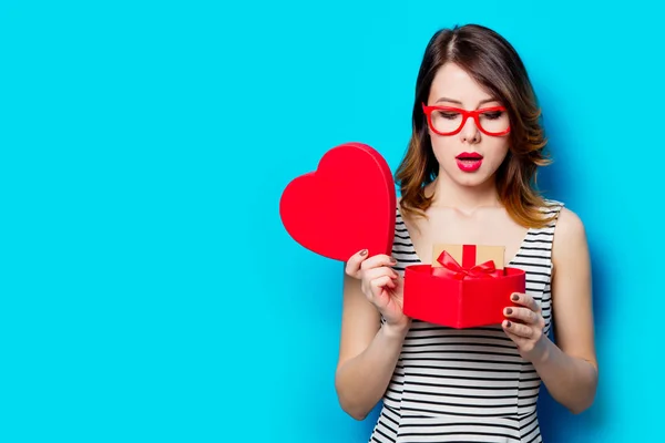 Young woman with heart shaped gift — Stock Photo, Image