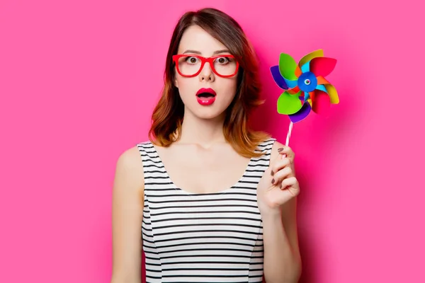 Beautiful young woman with toy windmill — Stock Photo, Image