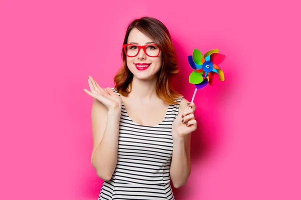 Beautiful young woman with toy windmill — Stock Photo, Image