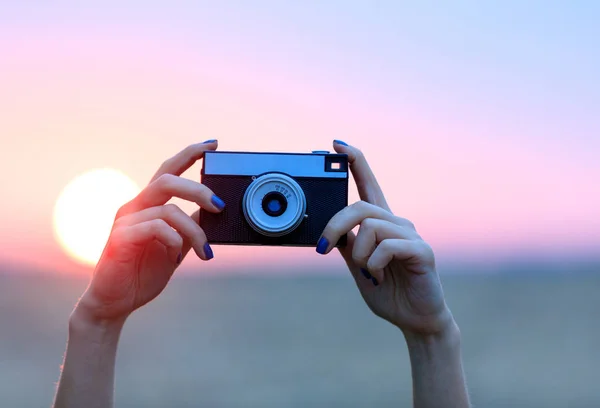 Female hands with camera — Stock Photo, Image