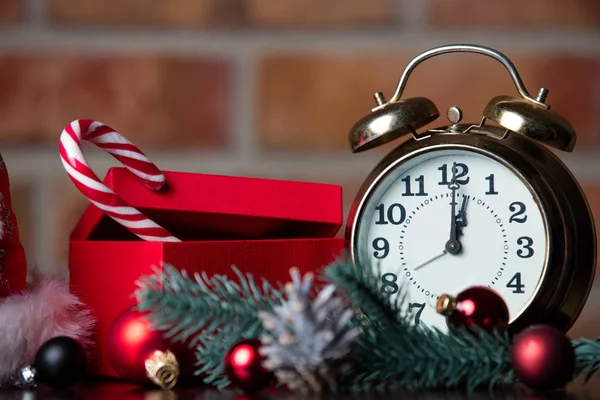 Gift, alarm clock and Christmas decorations — Stock Photo, Image