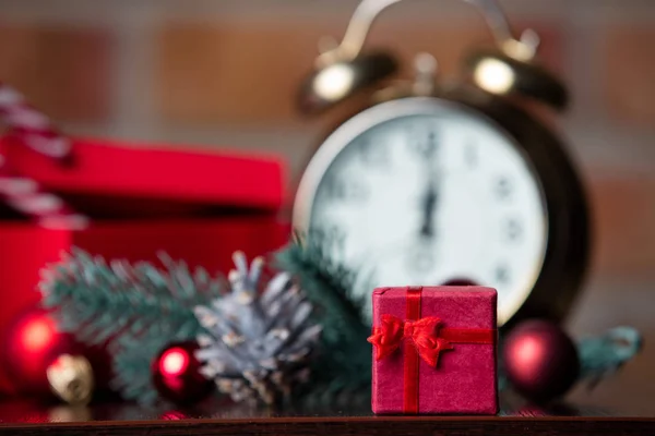 Gifts, alarm clock and Christmas decorations — Stock Photo, Image