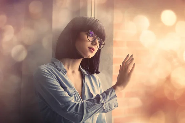 Woman looking at the window — Stock Photo, Image