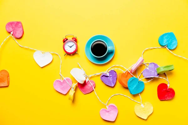 Lights and cup of coffee with clock — Stock Photo, Image