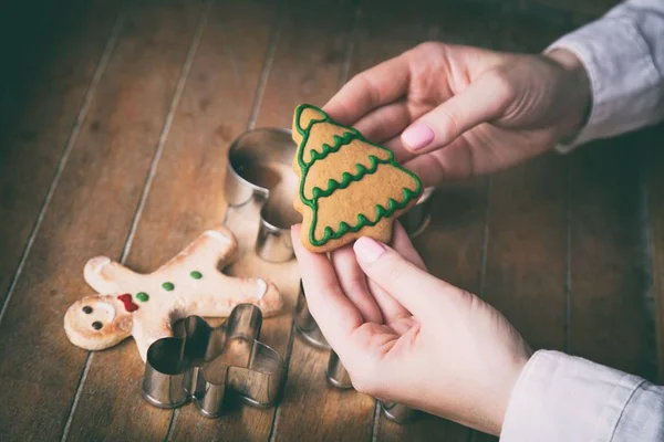 Hands holding christmas tree cookie — Stock Photo, Image