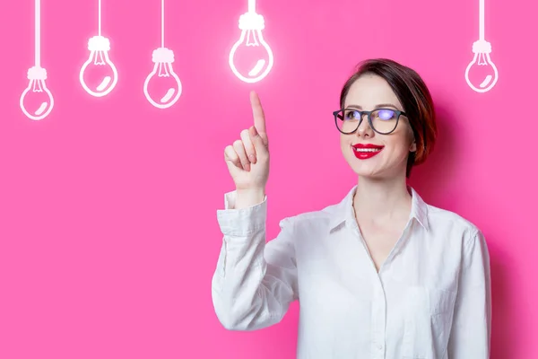 Puzzled businesswoman with abstract lamps — Stock Photo, Image