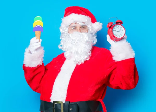 Santa Claus  with ice-cream and alarm clock — Stock Photo, Image