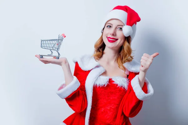 Santa girl with shopping cart — Stock Photo, Image