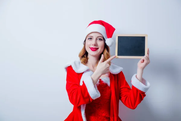 Santa chica en el tablero de ropa roja — Foto de Stock