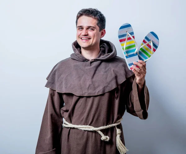 Monk with vacation flip flops — Stock Photo, Image