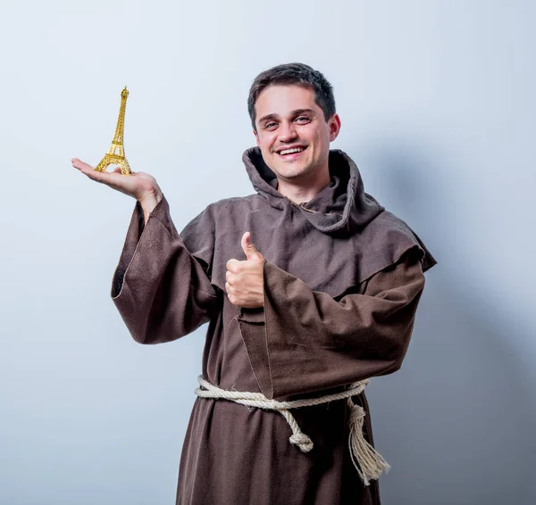 Catholic monk with Eiffel tower gift — Stock Photo, Image