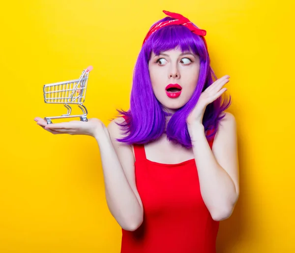 Young woman with small supermarket cart — Stock Photo, Image