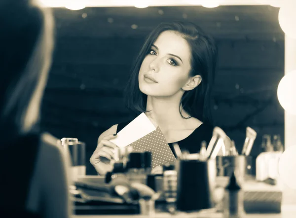 Beautiful woman at makeup mirror — Stock Photo, Image