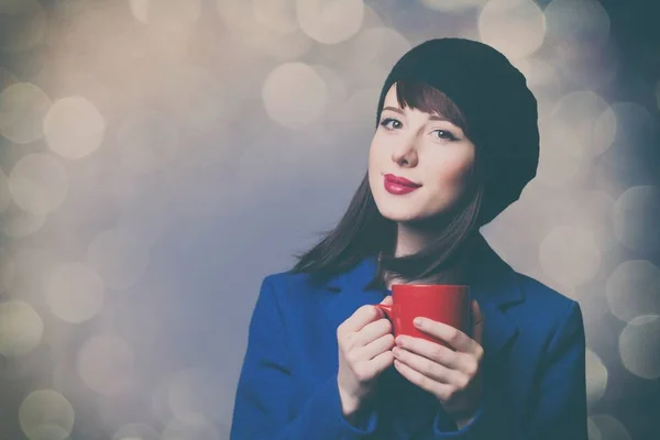 Woman in blue dress with red cup — Stock Photo, Image