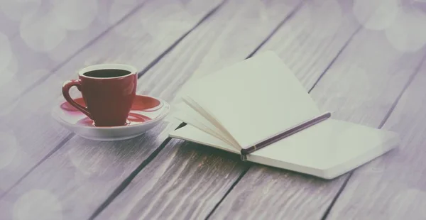 Cup of coffee and notebook — Stock Photo, Image