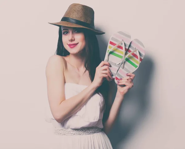 Young woman holding flip flops — Stock Photo, Image