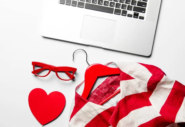 Jacket on hanger and laptop — Stock Photo, Image