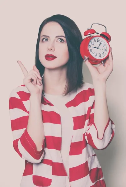 Menina com relógio de alarme — Fotografia de Stock