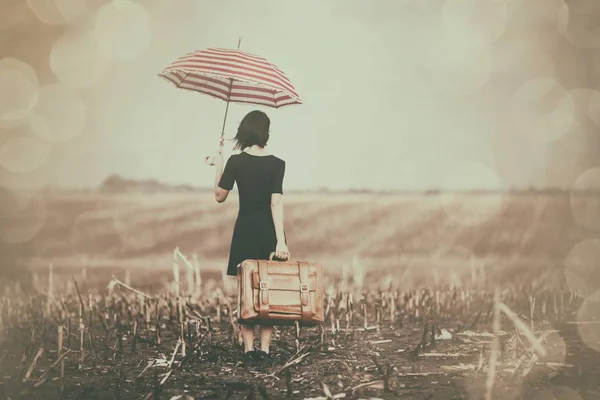 Young woman with suitcase and umbrella — Stock Photo, Image