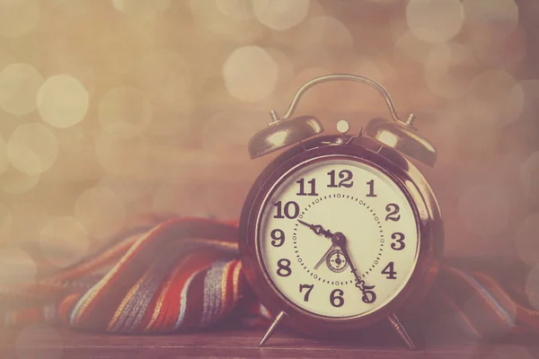 Alarm clock and scarf — Stock Photo, Image