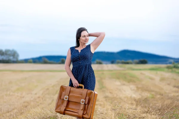 Portrait of senior woman with travel suitcase — Stock Photo, Image