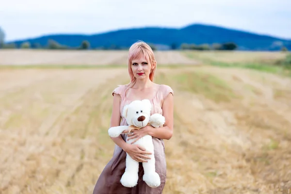 Woman with teddy bear — Stock Photo, Image