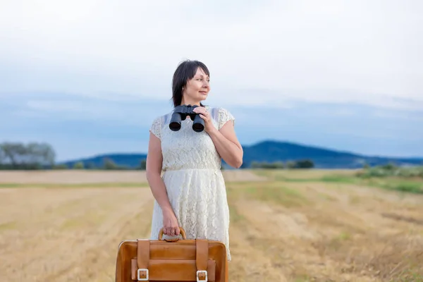 Portrét starší ženy s cestovní kufr — Stock fotografie