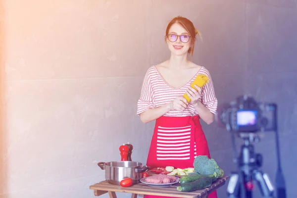 Young woman cooking at camera — Stock Photo, Image