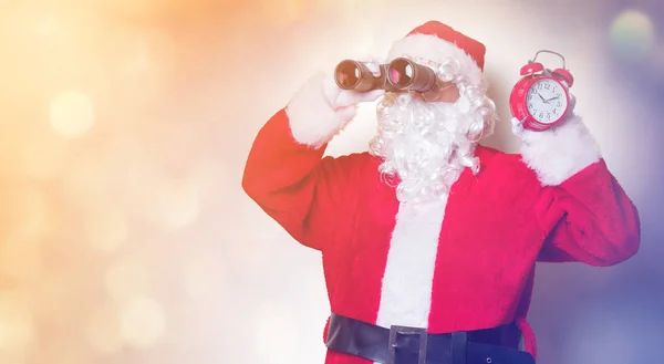 Santa Claus holding binoculars — Stock Photo, Image