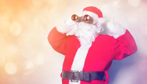 Santa claus s dalekohledem — Stock fotografie