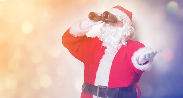 Santa Claus hospodářství dalekohled — Stock fotografie