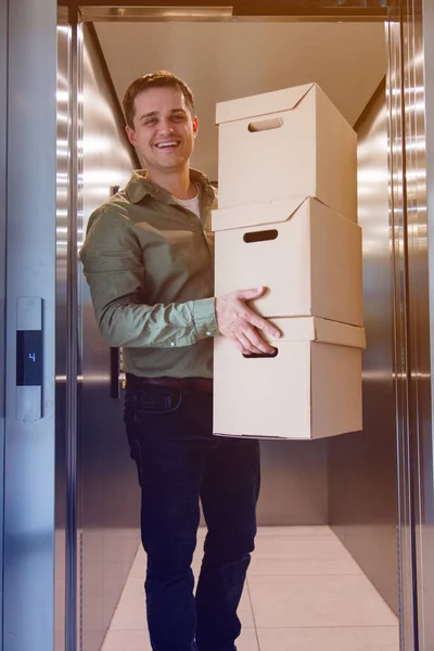 man with boxes coming out of lift