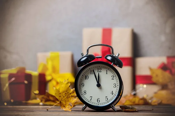 Retro alarm clock with maple leaves — Stock Photo, Image